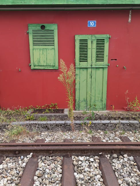 A bright red building with green shutters and the number 10